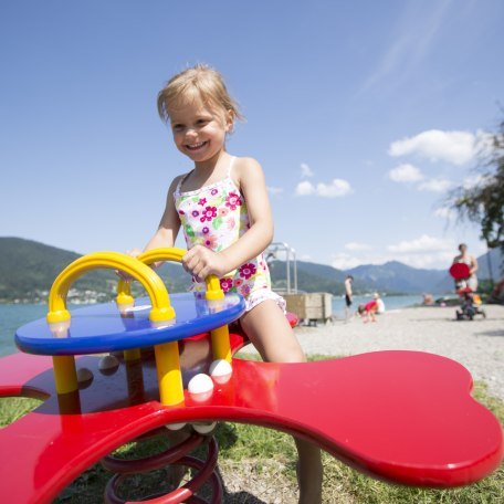 Girl on playground equipment, © Hansi Heckmair