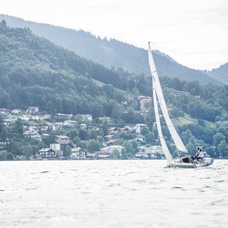 Ein Segelboot segelt auf dem Tegernsee mit Blick auf Stadt Tegernsee., © Hansi Heckmair